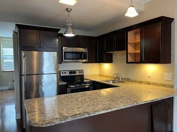 Buffalo apartment for rent - A kitchen with a granite countertop and stainless steel appliances.