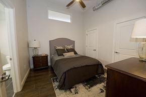 Buffalo apartment for rent - A bedroom with a bed, nightstands, and a ceiling fan.