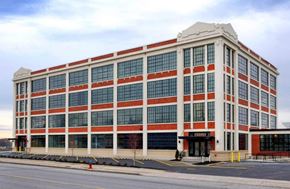 Buffalo apartment for rent - A large red and white building with many windows.