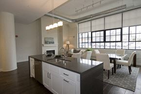 Buffalo apartment for rent - A modern kitchen with white cabinets and a black countertop.