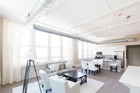 Buffalo apartment for rent - a living room with a couch and a table and a kitchen