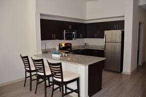 Boynton Beach apartment for rent - A kitchen with a white counter top and brown chairs.