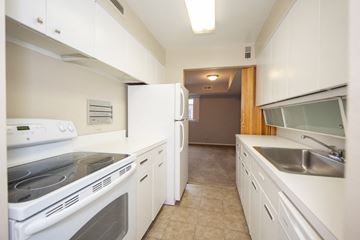 Shaker Heights apartment for rent - a kitchen with white cabinets and appliances and a stainless steel sink