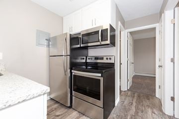 Woodmere apartment for rent - a kitchen with stainless steel appliances and white cabinets