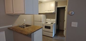 Lakewood apartment for rent - a kitchen with white appliances and a granite counter top