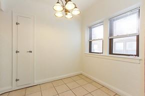 Cleveland Heights apartment for rent - a bedroom with two windows and a door and a tiled floor