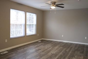 Rocky River apartment for rent - an empty living room with wood floors and a ceiling fan