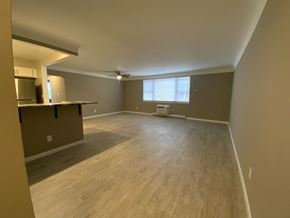 Shaker Heights apartment for rent - an empty living room with a kitchen and a window