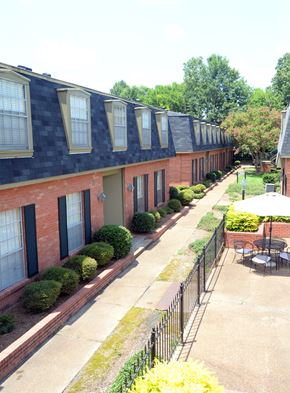 Jackson apartment for rent - A long building with a black fence in front.