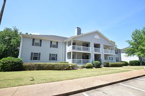 Vicksburg apartment for rent - A two-story apartment building with a balcony on the second floor.