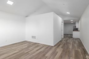 Oklahoma City apartment for rent - A room with wooden flooring and white walls.