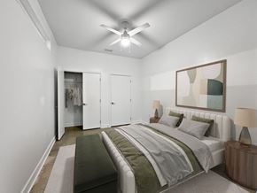 Silver Spring apartment for rent - A bedroom with a bed, nightstand, and a painting on the wall.