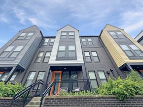 Silver Spring apartment for rent - A modern building with a unique design featuring a combination of grey and yellow panels.