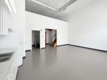 Mount Rainier apartment for rent - A kitchen with white cabinets and a white fridge.