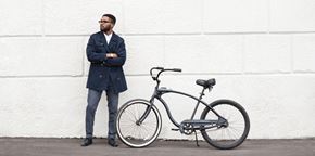 Washington apartment for rent - A man in a dark coat stands next to a black bicycle.
