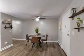 Cincinnati apartment for rent - A dining room with a table and chairs in a 1 bedroom, 1 bath 560 square foot apartment at Aspen Village Apartments in the Westwood neighborhood of Cincinnati, OH.