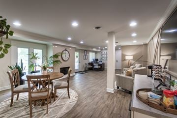 Erlanger apartment for rent - A well-lit living room with a dining table and chairs.