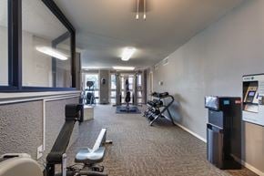Dallas apartment for rent - The fitness center with rowing machine, elliptical, treadmill, bike, weight system and free weights at Cambridge Court Apartments in Lake Highlands, Dallas, TX.