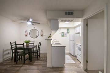 Dallas apartment for rent - A kitchen with a dining table and chairs.