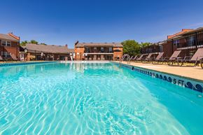 Mt. Healthy apartment for rent - inviting swimming pool and lounge chairs at Compton Lake Apartments on a sunny day