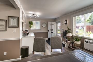 Cincinnati apartment for rent - A living room with a grey couch and a white framed picture on the wall.