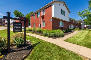 Cincinnati apartment for rent - Colonial Ridge Apartments sign with brick apartment homes and landscaped lawn in Pleasant Ridge