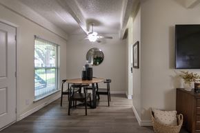 Dallas apartment for rent - Dining area and living room view with large window in a one-bedroom apartment home at Harvard Square Apartments