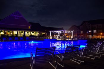 Poolside pavilion with fire pit, outdoor appliances, and 46 inch flat-screen tv