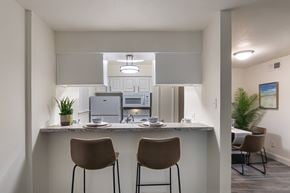Dallas apartment for rent - Breakfast bar with seating overlooking the kitchen and living area at The Summit at Midtown in Dallas, TX