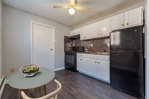 Philadelphia apartment for rent - A kitchen with black appliances and white cabinets.