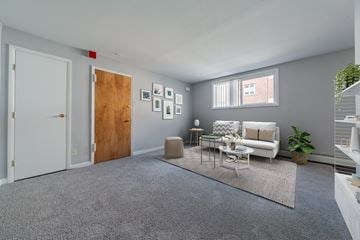 Philadelphia apartment for rent - A living room with a grey carpet and a white sofa.