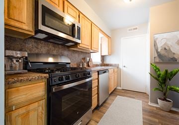 Philadelphia apartment for rent - A kitchen with wooden cabinets and a black stove top oven.
