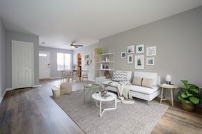Philadelphia apartment for rent - A living room with a white couch, a green chair, and a rug.