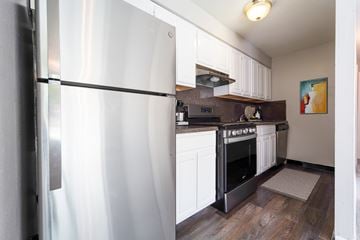Philadelphia apartment for rent - A modern kitchen with a white refrigerator and black oven.
