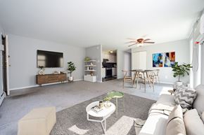 Philadelphia apartment for rent - A living room with a white couch, a coffee table, and a ceiling fan.