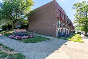 Philadelphia apartment for rent - A brick building with a sign that says Woodbridge News in front of it.