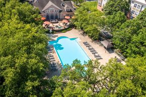 Eagleville apartment for rent - A large swimming pool surrounded by trees and a building in the background.at Riverview Landing @ Valley Forge, Pennsylvania, 19403