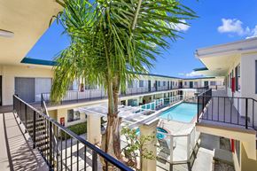 Torrance apartment for rent - a balcony with a pool and a palm tree at Olive Tree Apartments, Torrance