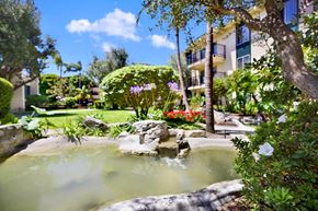 Torrance apartment for rent - a spa with a fountain in the middle of a garden at Willow Tree Apartments, Torrance