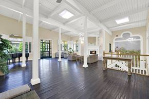 Torrance apartment for rent - a large living room with a fireplace and a staircase at Willow Tree Apartments, Torrance, CA