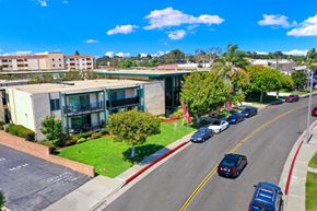 Torrance apartment for rent - an aerial view of a building with cars parked in front of it at Casa Del Amo Apartments, California