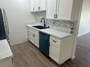 Torrance apartment for rent - A kitchen with white cabinets and a blue dishwasher. at Camino de Oro Apartments, Torrance, CA, 90505