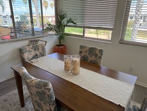 Redondo Beach apartment for rent - A dining room with a wooden table and chairs.