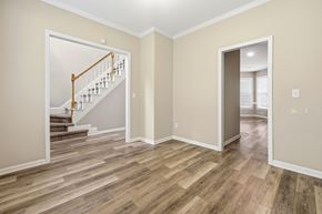 Wake Forest apartment for rent - A room with a wooden floor and a staircase.