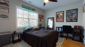 Raleigh townhouse for rent - A bedroom with a bed, desk, and chair.