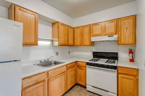 Chester apartment for rent - a kitchen with white appliances and wooden cabinets