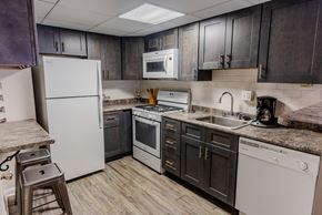 Philadelphia apartment for rent - an updated kitchen with white appliances and dark cabinets