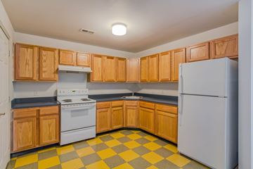 Camden apartment for rent - a kitchen with white appliances and wooden cabinets