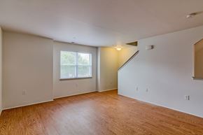 Camden apartment for rent - the living room and dining room of an empty house with wood flooring