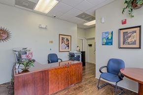 Camden apartment for rent - a doctors office with a wooden reception desk and blue chairs